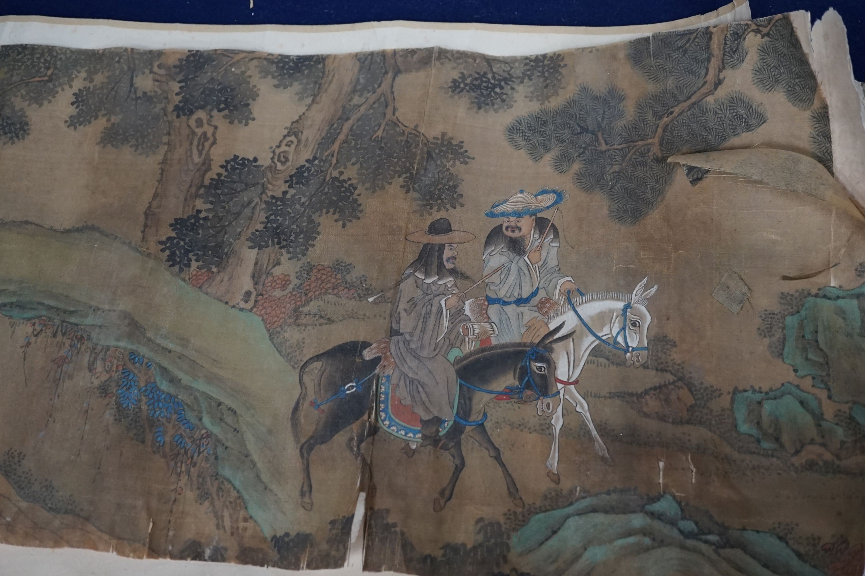 A 19th century Chinese hand scroll painting on silk of figures in a landscape, approximately 206 cm X 32.5 cm